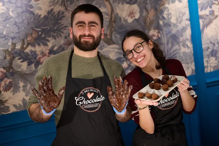 Hands rolling chocolate truffles in a Brussels chocolate workshop, one of the hands-on chocolate tours in Brussels