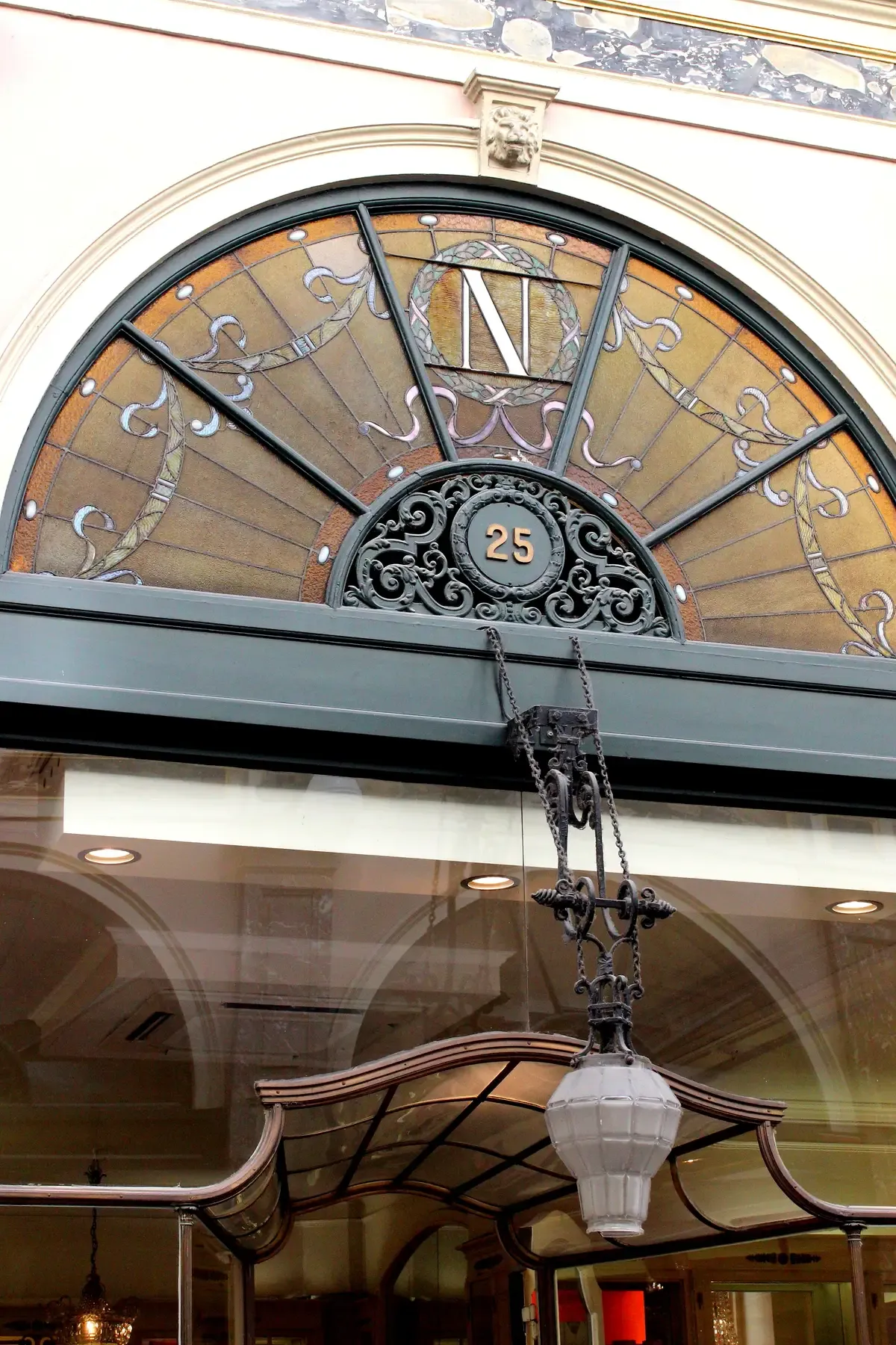 The arched Neuhaus shopfront at Galerie de la Reine 25 in the Galeries Royales Saint-Hubert, the centre of a self-guided chocolate tour in Brussels