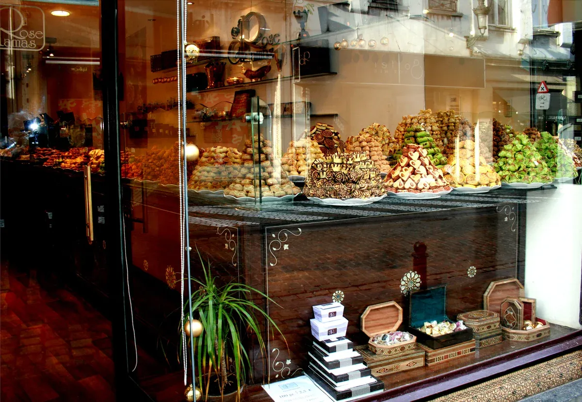 A Brussels chocolate shop window stacked with pralines and gift boxes, the last stop of many chocolate tours in Brussels